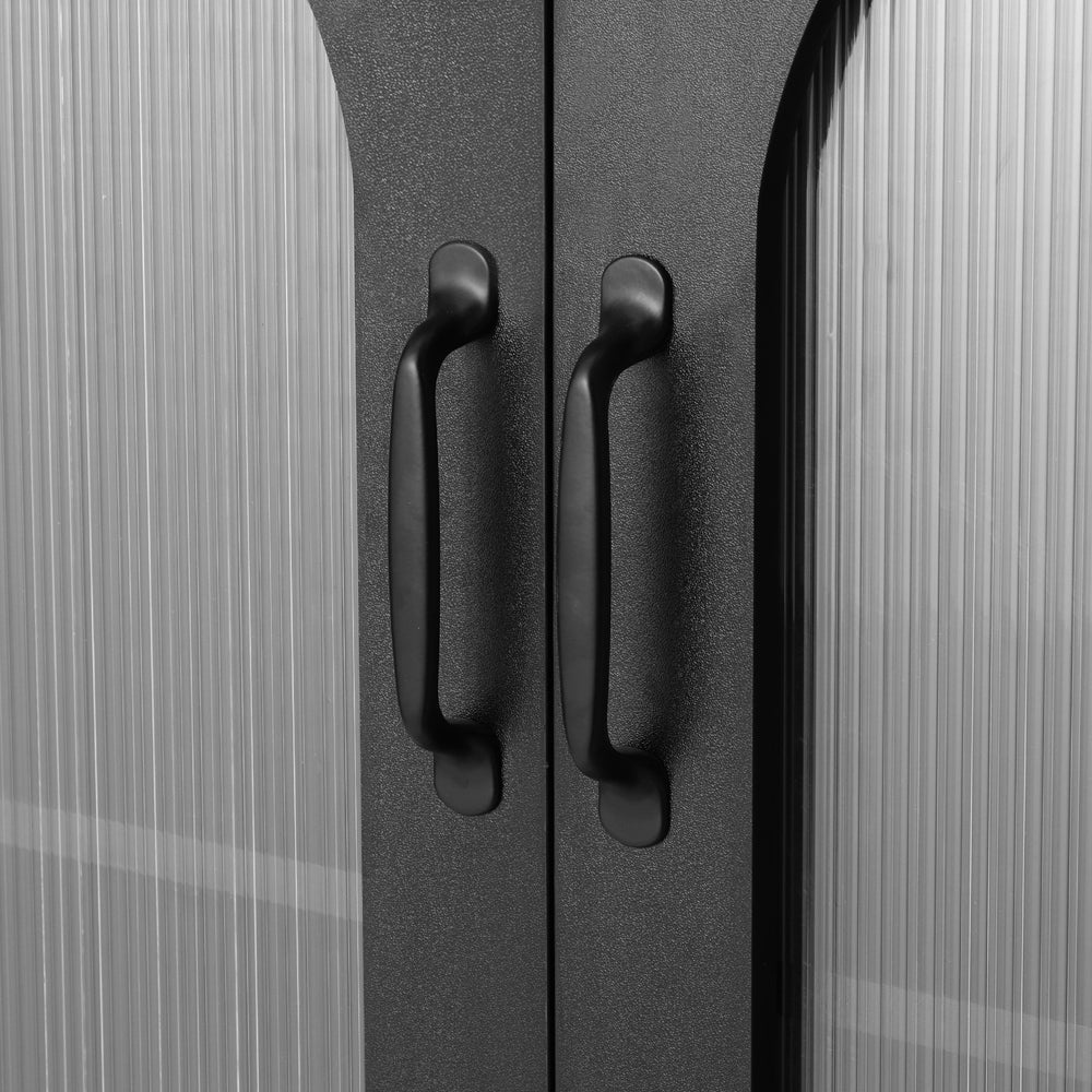 Close-up of two matte black bar handles on ribbed glass cabinet doors