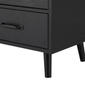 Close-up of black sideboard bottom drawer with bar handle and tapered leg on white background