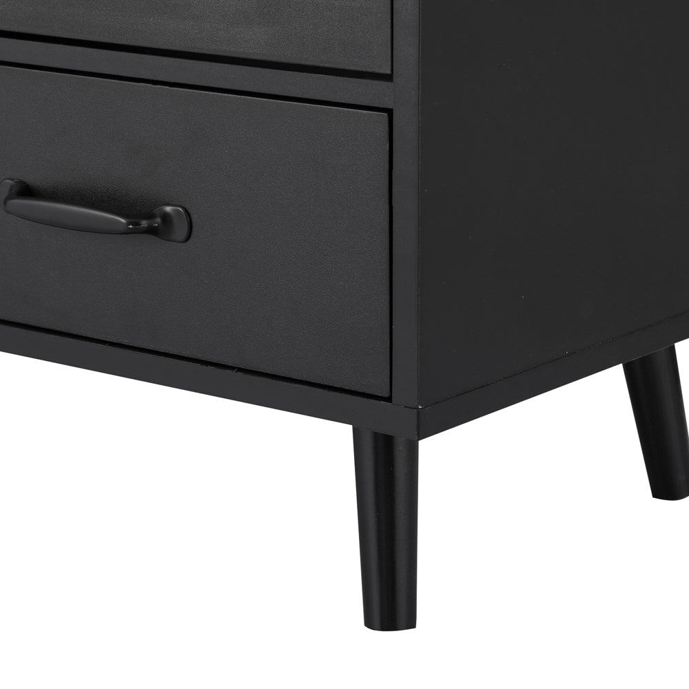 Close-up of black sideboard bottom drawer with bar handle and tapered leg on white background