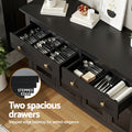 Black sideboard two open drawers filled with cutlery, text: Two spacious drawers, stepped edge tabletop, gold knob handles