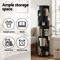 Black spiral rotating bookshelf in bedroom showing 5kg per tier capacity and icons for potted plant, book, toy and clock