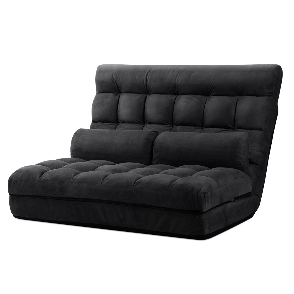 Black suede 2-seat floor lounger upright on white background, front-right angle, two bolster pillows