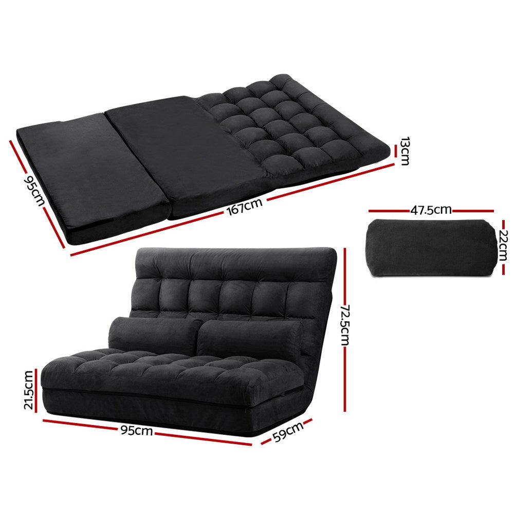 Black charcoal suede floor lounger upright against coral pink wall with tufted seat and built-in backrest bolster