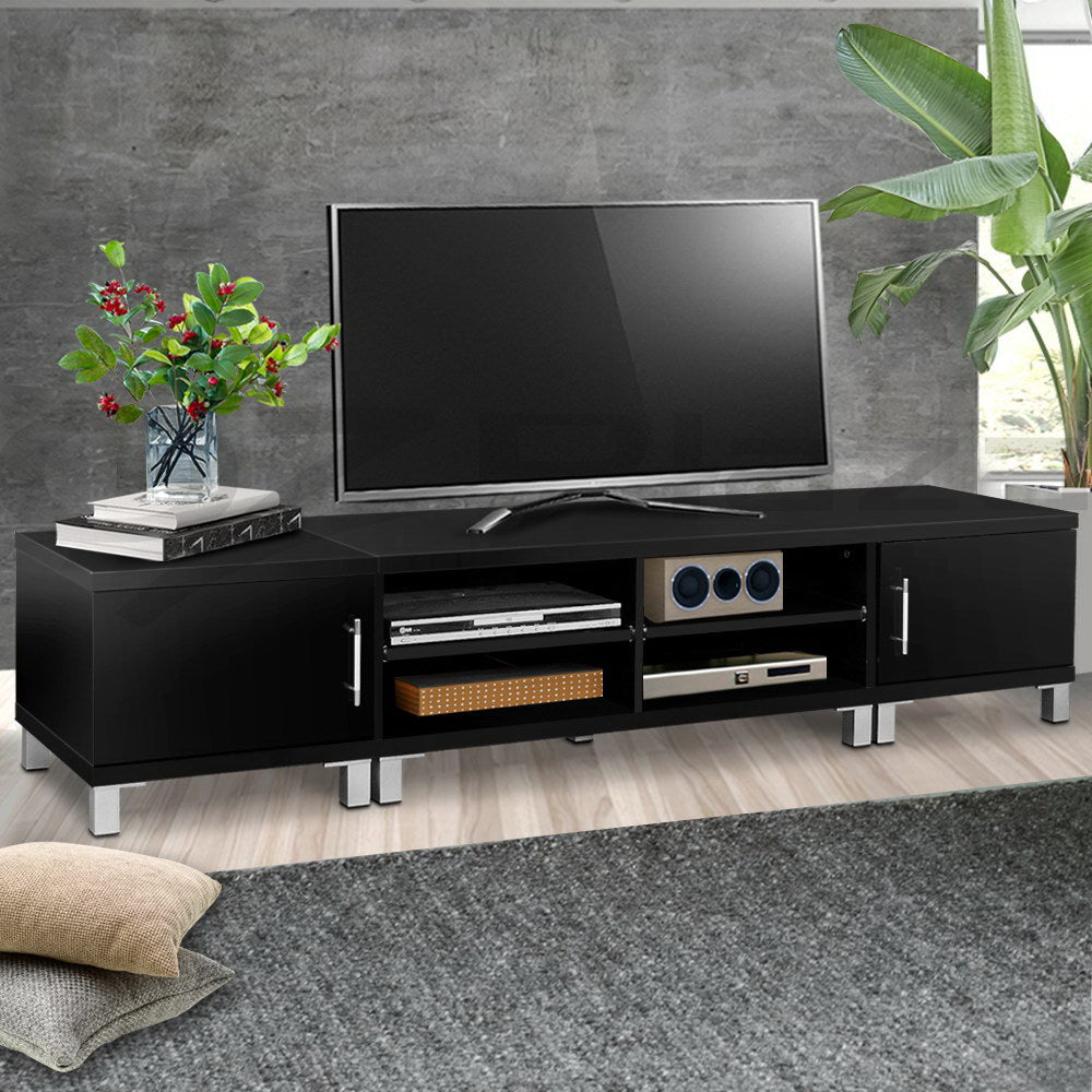 Black TV unit 160cm lifestyle in concrete room with TV on wall gaming gear two side doors bar handles and center shelves