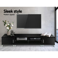Black TV unit 190cm sleek style lifestyle in grey room with wall-mounted TV white flowers and AV equipment