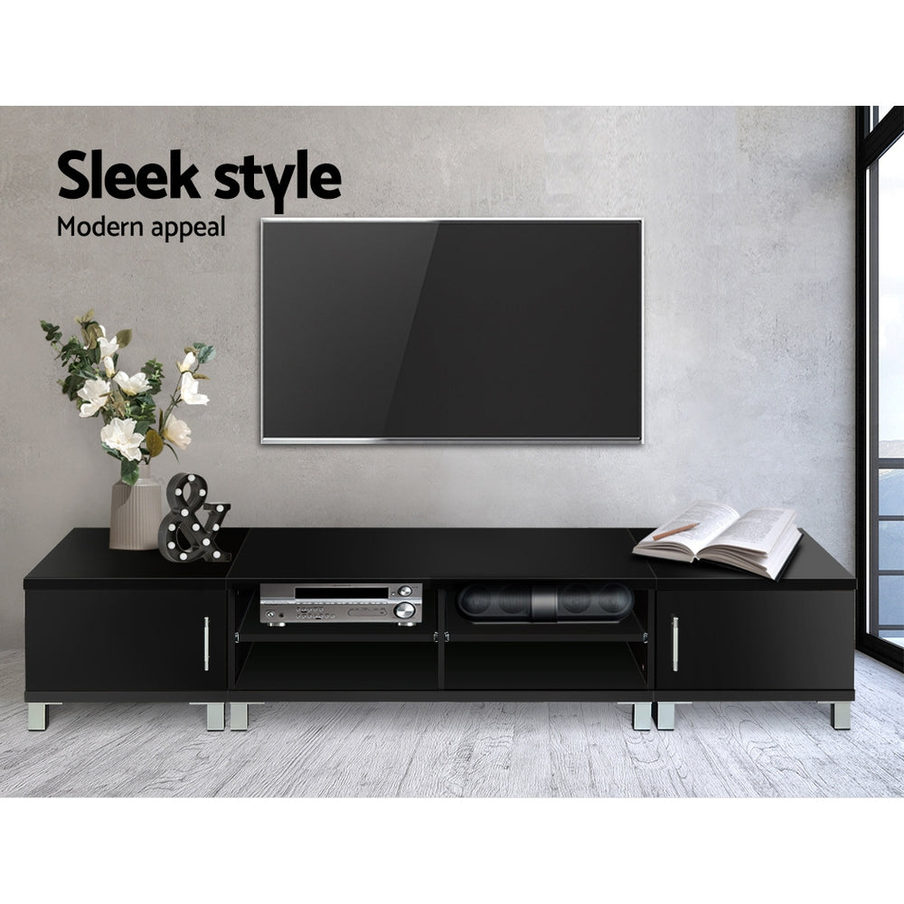 Black TV unit 190cm sleek style lifestyle in grey room with wall-mounted TV white flowers and AV equipment