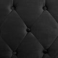Close-up of black velvet sofa bed diamond button tufting texture detail