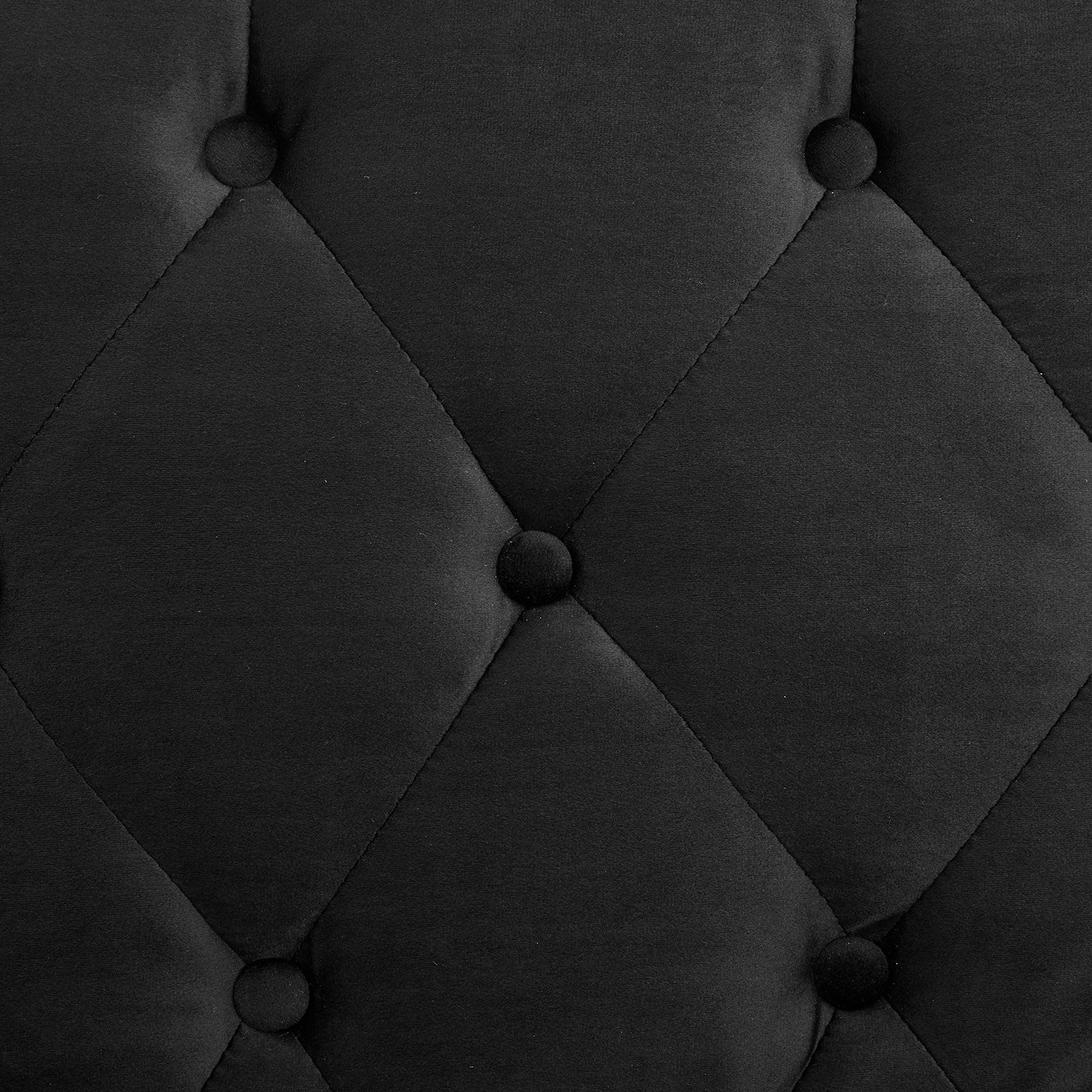 Close-up of black velvet sofa bed diamond button tufting texture detail