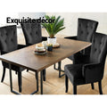 Four black velvet wingback armchairs around walnut herringbone dining table in room scene with Exquisite decor text