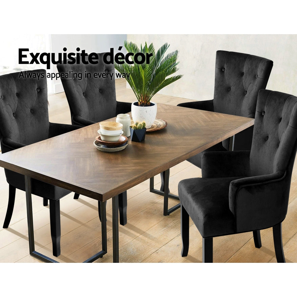 Four black velvet wingback armchairs around walnut herringbone dining table in room scene with Exquisite decor text
