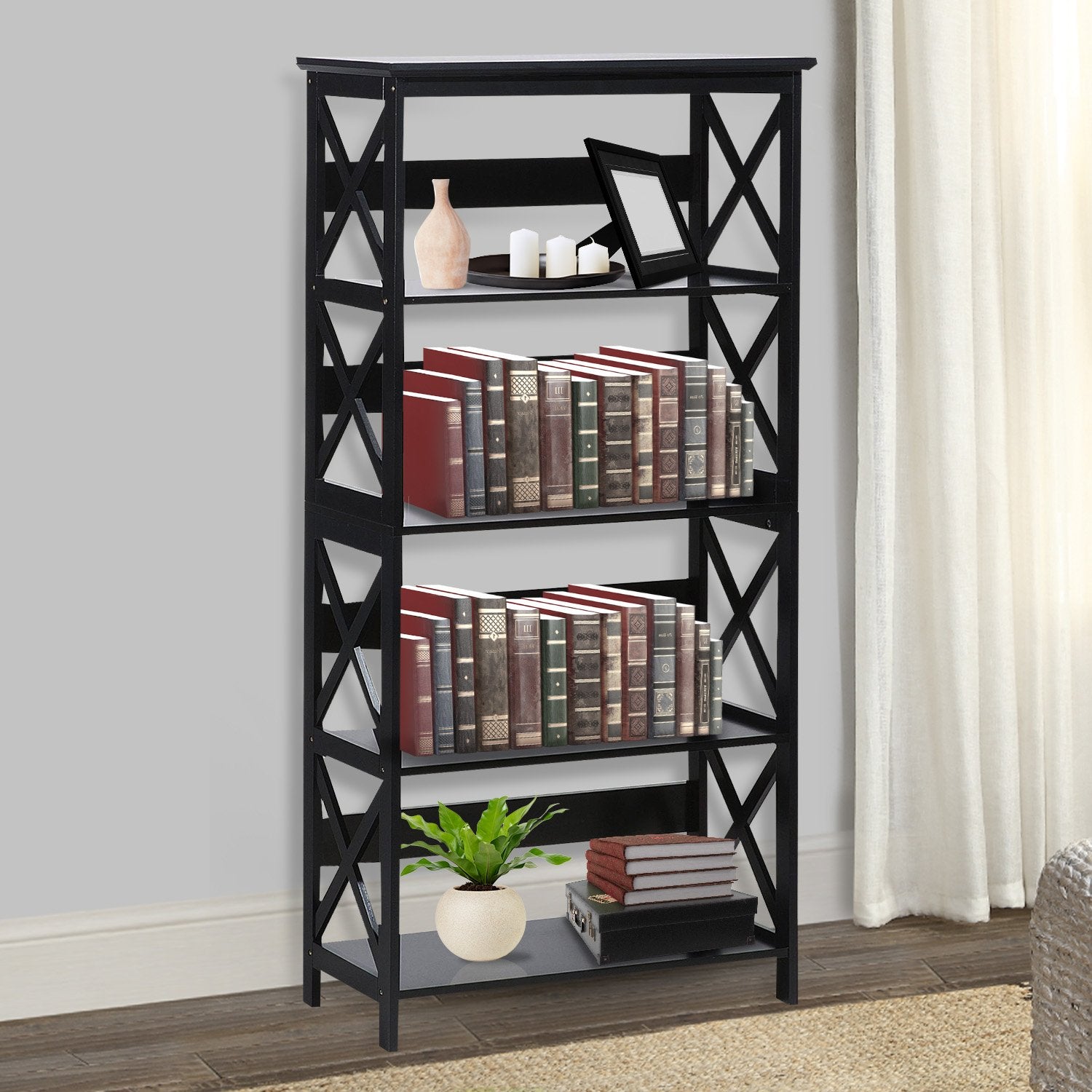 5-tier black X-frame bookshelf in living room styled with books, candles, vase and plant, grey wall and hardwood floor