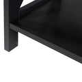 Close-up detail of lower corner of black X-frame bookshelf showing bottom shelf, leg and matte black surface finish