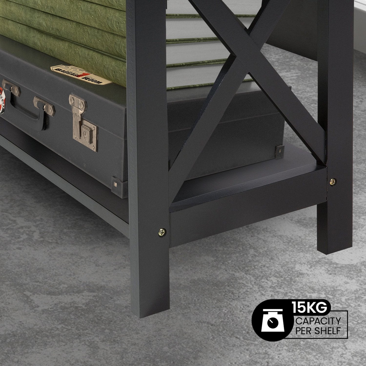 Close-up of black X-frame bookshelf base with vintage suitcase on bottom shelf and badge: 15KG capacity per shelf