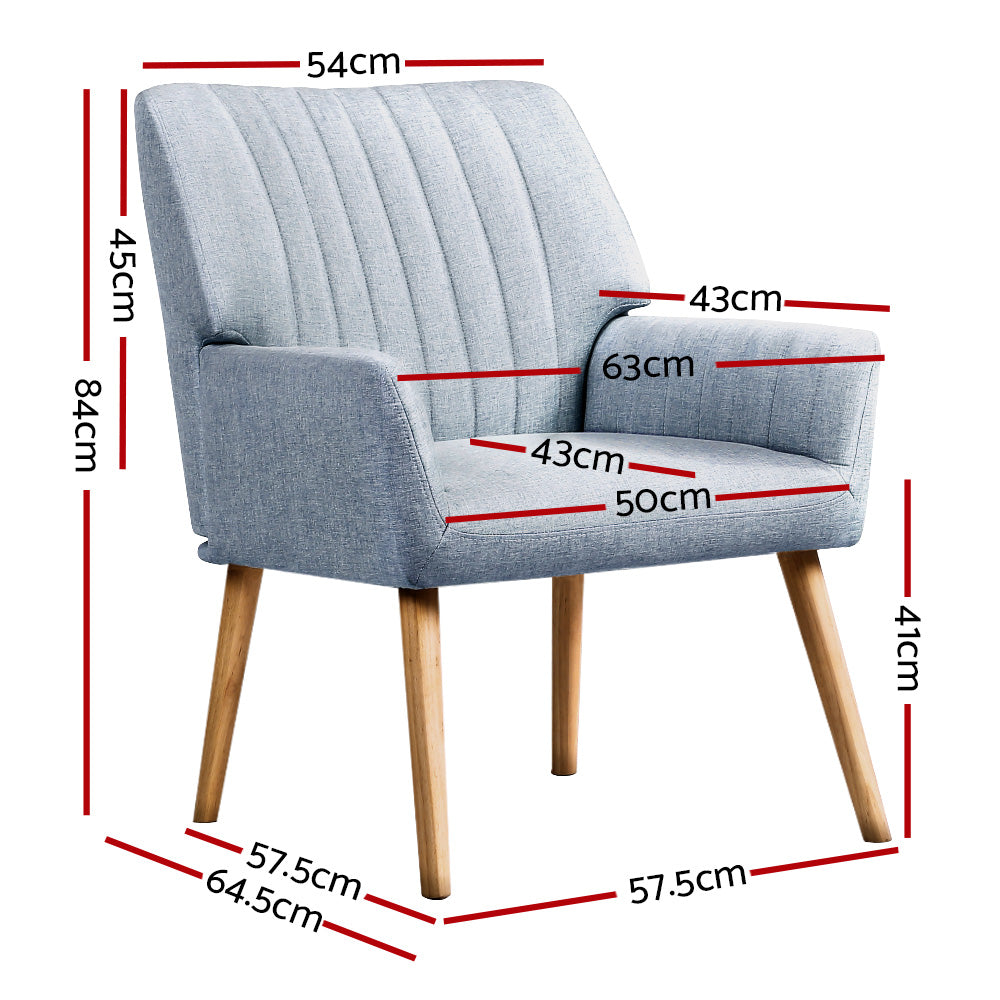 Pair of light blue grey fabric armchairs with vertical channel-stitched backrest and natural wood legs, white background