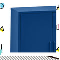 Navy blue metal locker cabinet top corner close-up showing door seam and D-ring handle, colourful geometric shapes on border
