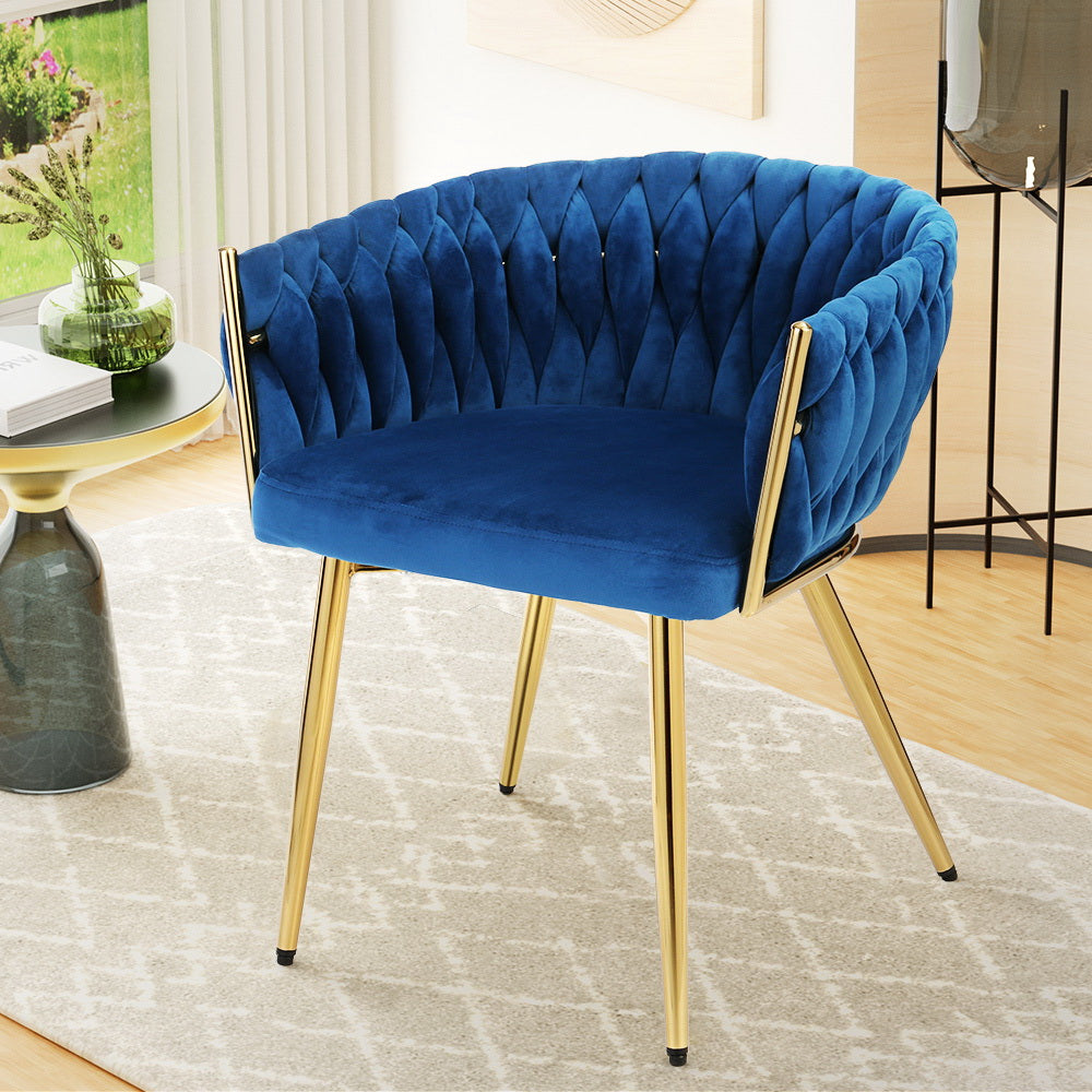 Blue velvet accent chair with woven braided backrest and gold metal legs in living room with round side table