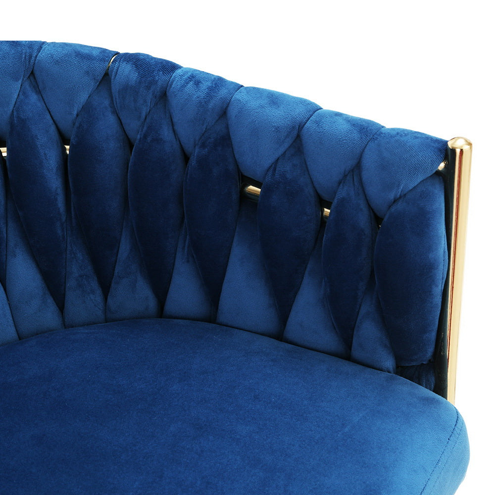 Close-up rear view of blue velvet chair showing braided woven backrest pattern with gold metal frame bars at sides