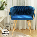 Blue velvet woven back chair with gold metal legs in room setting, 