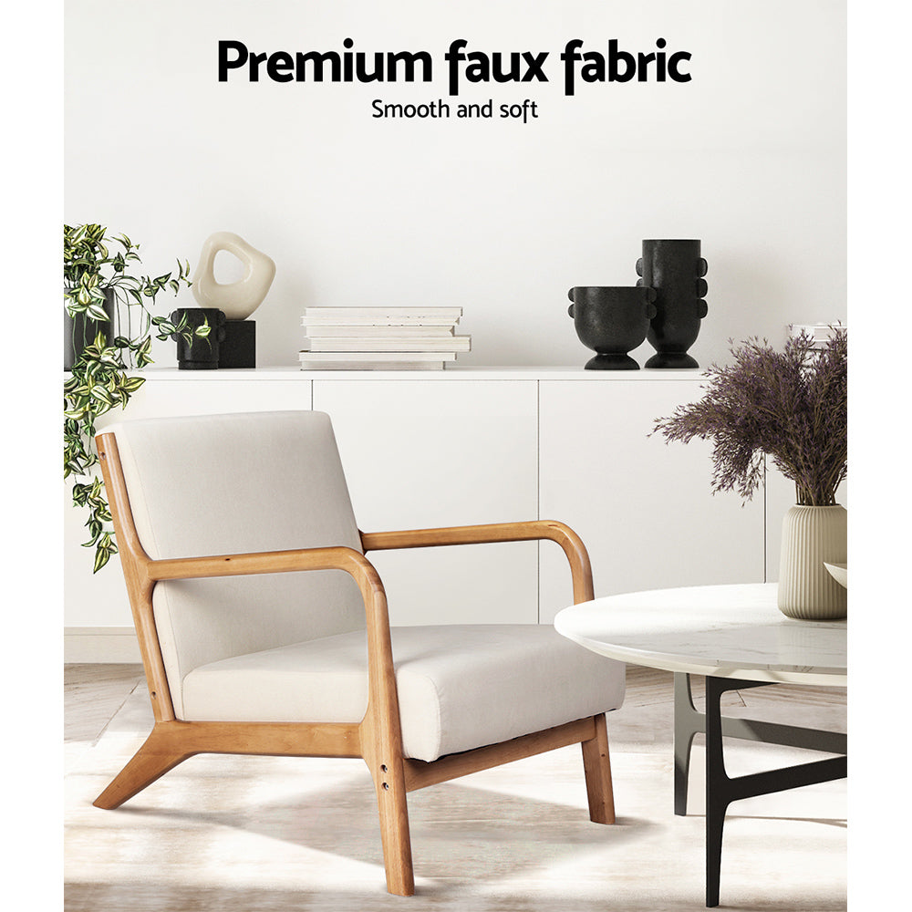 Cream fabric armchair with wood frame in modern living room with white sideboard, decorative objects and marble coffee table