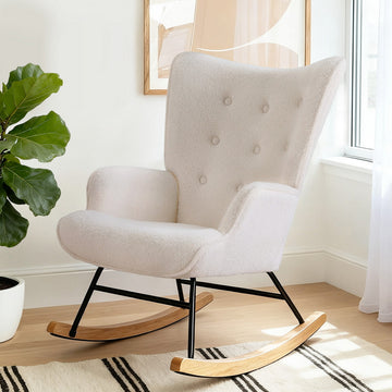 White boucle wingback rocking chair with button-tufted back, black metal frame and wood rockers in light room