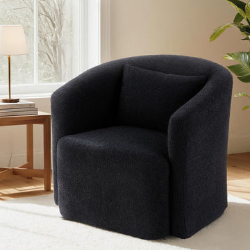 Black boucle swivel barrel chair with back cushion in room with side table and gold lamp