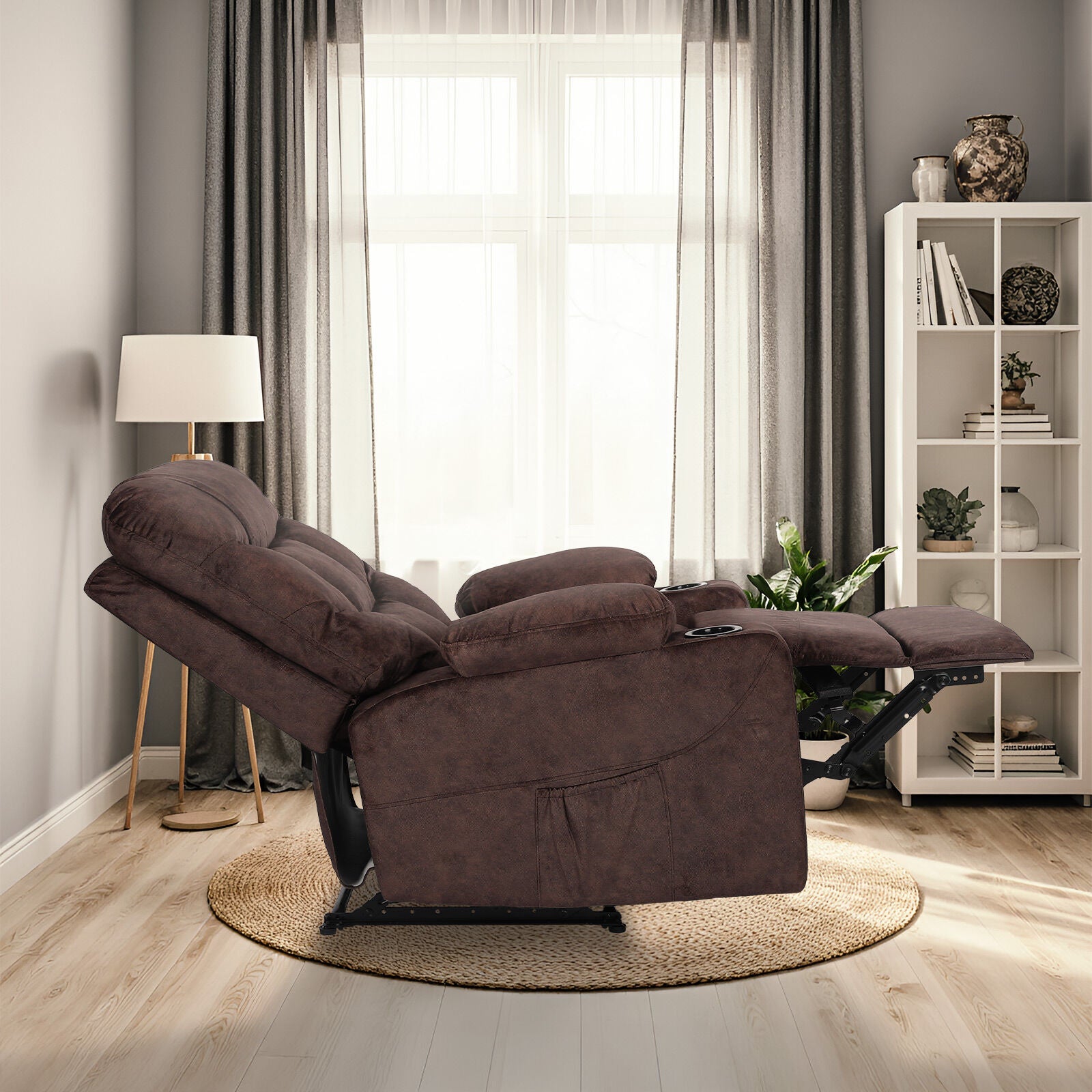 Brown fabric tufted recliner fully reclined with footrest extended, side view in living room with bookshelf and floor lamp
