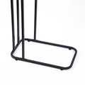 Close-up of black metal rectangular base frame of C-frame side table showing rubber feet on white background