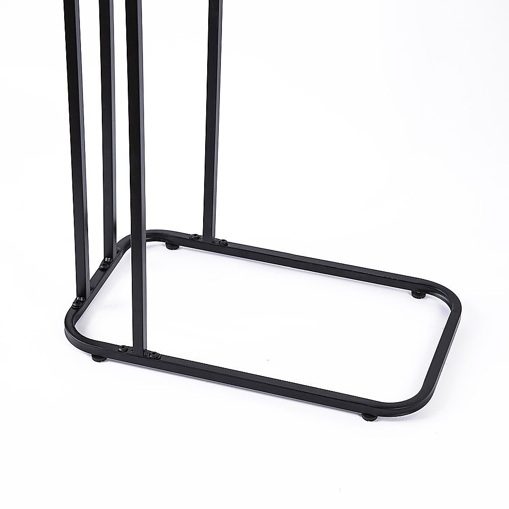 Close-up of black metal rectangular base frame of C-frame side table showing rubber feet on white background
