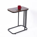 C-frame side table with rectangular walnut-look top holding smartphone and red mug, angled view on white background
