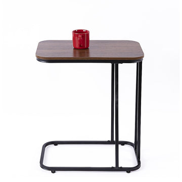 C-frame side table with rectangular walnut-look top and black metal frame holding red mug on white background