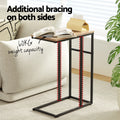C-shaped side table beside a cream sofa with a book and tissue box on top, annotated with 60KG capacity and dual bracing.