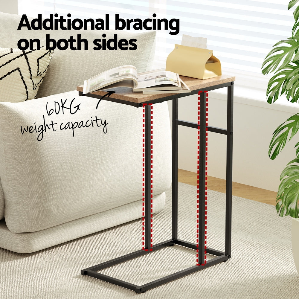 C-shaped side table beside a cream sofa with a book and tissue box on top, annotated with 60KG capacity and dual bracing.