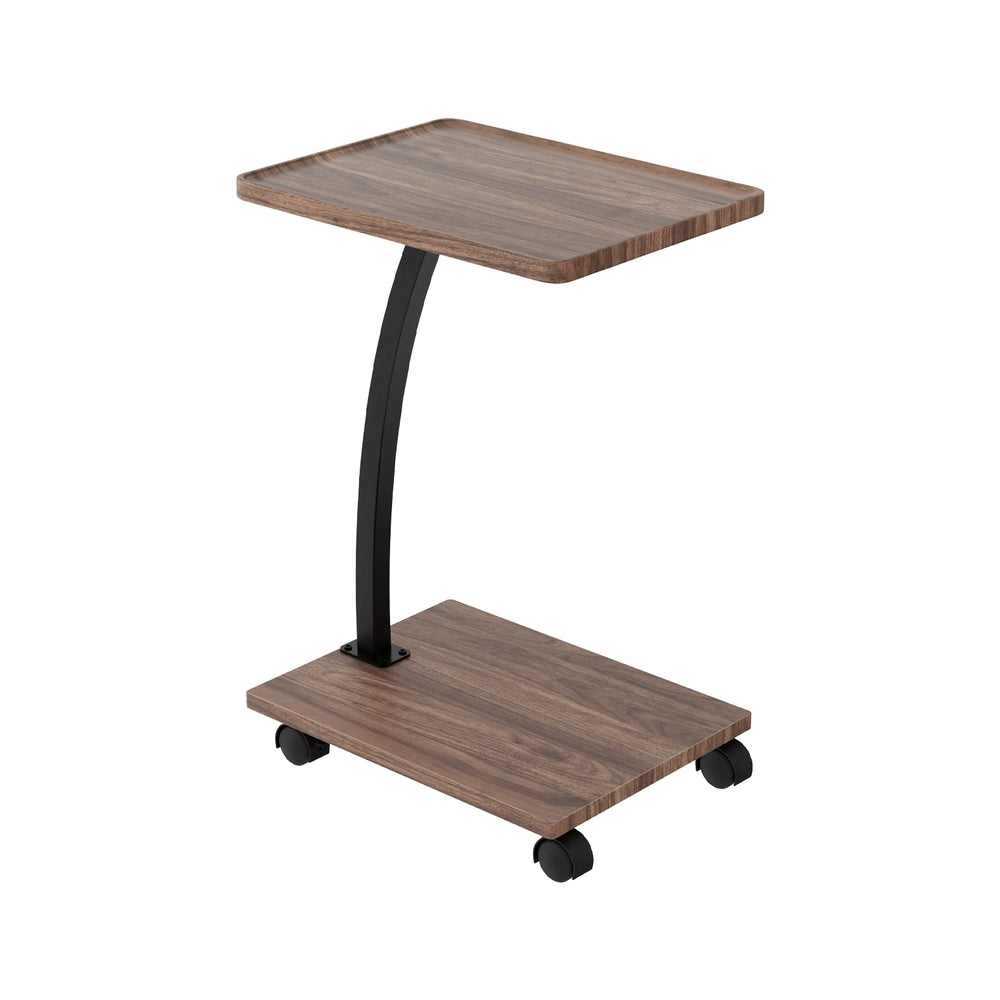 C-shaped mobile side table angle view, walnut tray top and base, curved black metal post, four castors, white background