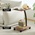 C-shaped side table with 5kg weight capacity per shelf label, magazine on top, retro radio on lower shelf, beside cream sofa