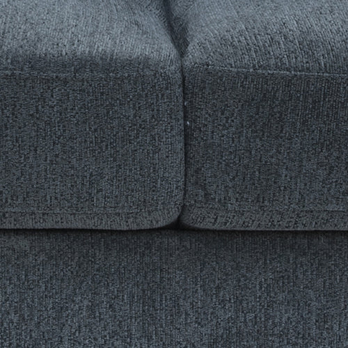 Close-up of charcoal chenille sofa showing the seam between two seat cushions and fabric texture