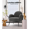 Charcoal boucle armchair in styled room with gold side table, 