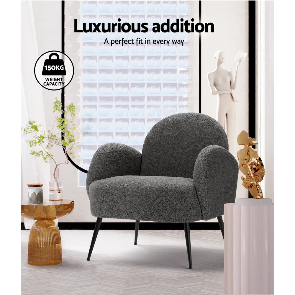 Charcoal boucle armchair in styled room with gold side table, "Luxurious addition" text and 150kg weight capacity badge
