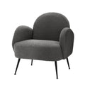 Charcoal grey boucle armchair with rounded cloud-shaped back, curved armrests and black metal tapered legs, angle view