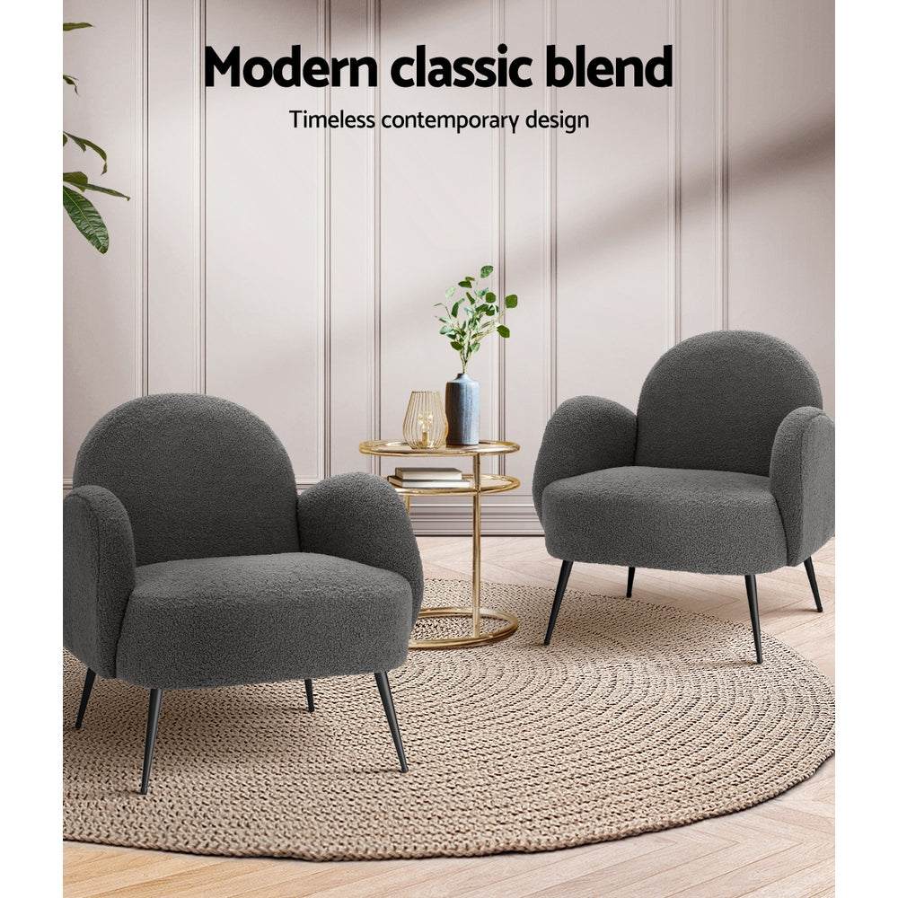Two charcoal boucle armchairs facing each other with gold side table on jute rug, "Modern classic blend" text