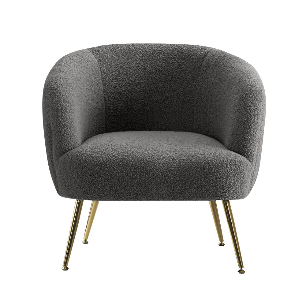 Charcoal grey boucle tub chair with rounded barrel back, integrated armrests and gold metal legs, front view