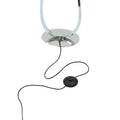 Close-up of chrome oval base with black power cord and round foot dimmer switch below