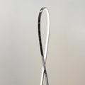 Close-up of upper teardrop loop top on grey background, dark chrome exterior with white LED strip along inner edge