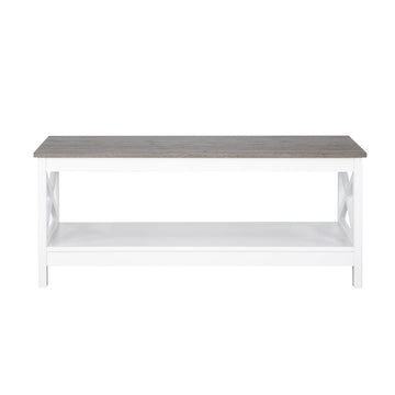 Rectangular coffee table with grey wood-look top and white X-frame base with lower shelf on white background