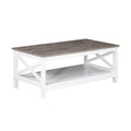 Rectangular coffee table with grey top and white X-frame legs with lower shelf, three-quarter angle view on white background