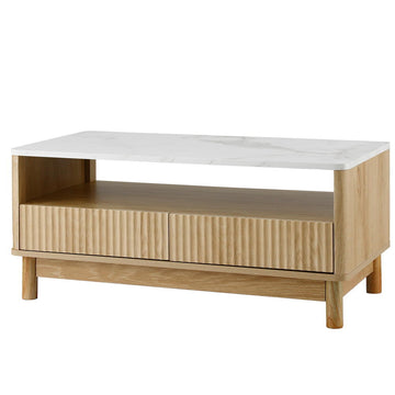 Coffee table with white marble top, open shelf and two fluted drawers, natural wood body and round legs on white background
