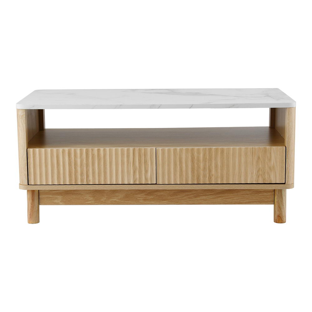 Coffee table front view on white background, white marble top, open shelf and two fluted drawers, round wood legs