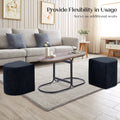 Three-piece coffee table and ottoman set front view: oval rustic wood tabletop on black metal frame with two navy fabric