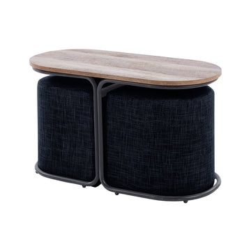 Oval wood-top coffee table and ottoman set in a living room in front of a cream sofa, two navy fabric ottomans seated under