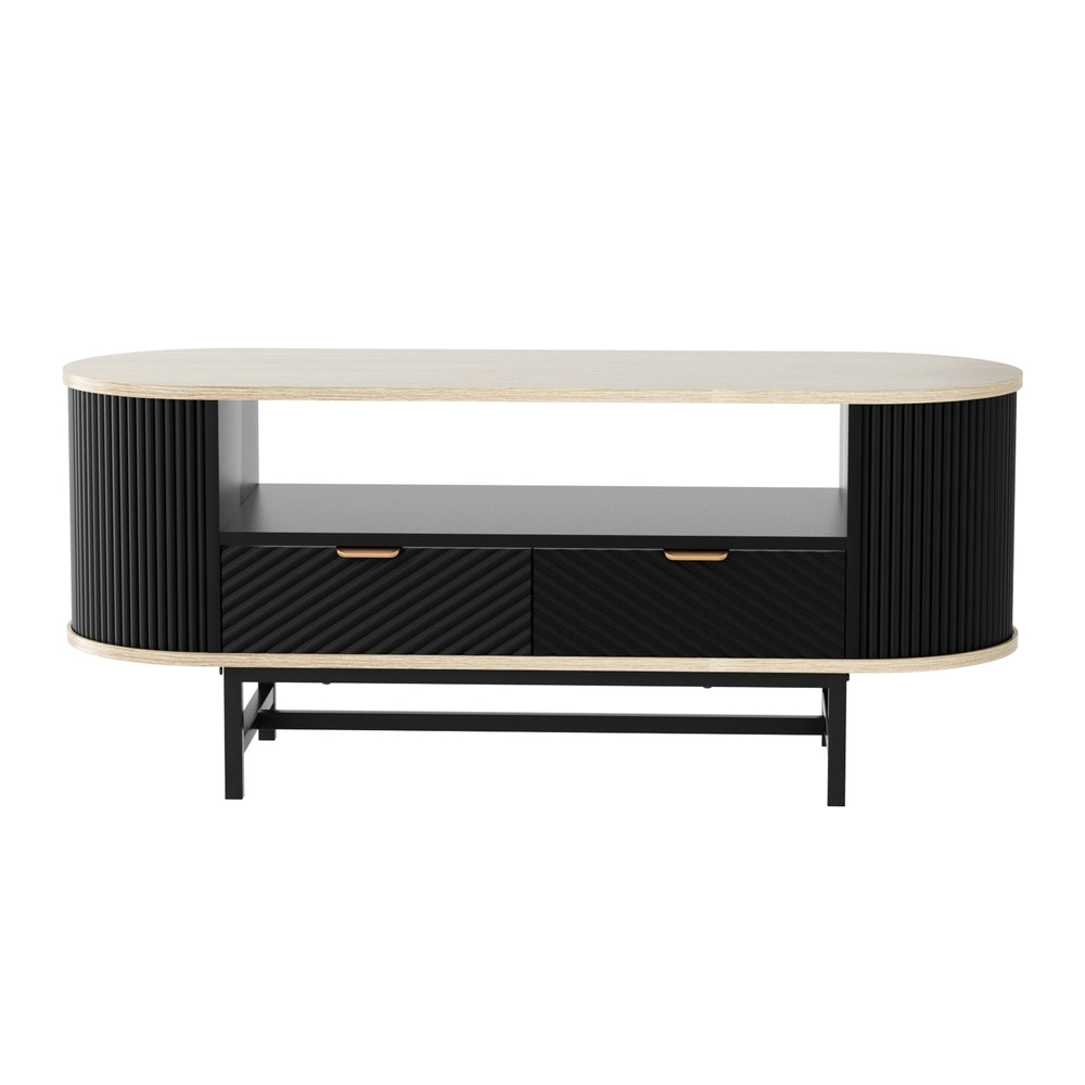Oval coffee table with oak-effect top, black fluted curved side panels, two drawers with gold handles, and open centre