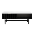 Front view of a white marble-top coffee table with black ribbed sliding drawer on the left, open shelf on the right, and